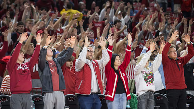  Arkansas Razorbacks fans raise their hands for the “calling of the Hogs” during the second half against Texas-San Antonio.