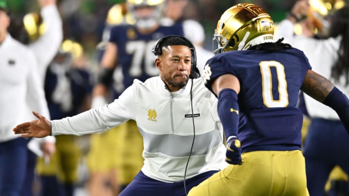 Oct 14, 2023; South Bend, Indiana, USA; Notre Dame Fighting Irish head coach Marcus Freeman celebrates with safety Xavier Watts (0) after Watts intercepted a pass in the first quarter against the USC Trojans at Notre Dame Stadium. Notre Dame won 48-20. Mandatory Credit: Matt Cashore-USA TODAY Sports