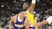 Oct 3, 2025; Palm Desert, California, USA; Los Angeles Lakers forward Rui Hachimura (28) defends against Phoenix Suns guard Devin Booker (1) during the second half at Acrisure Arena. Mandatory Credit: Denis Poroy-Imagn Images