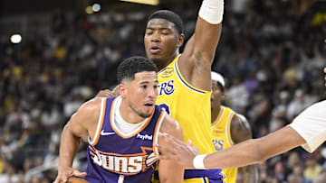 Oct 3, 2025; Palm Desert, California, USA; Los Angeles Lakers forward Rui Hachimura (28) defends against Phoenix Suns guard Devin Booker (1) during the second half at Acrisure Arena. Mandatory Credit: Denis Poroy-Imagn Images