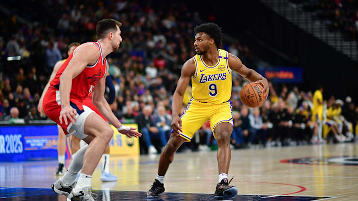 Los Angeles Lakers guard Bronny James (9) controls the ball against Los Angeles Clippers forward Drew Eubanks (15) during the second half at Intuit Dome. 