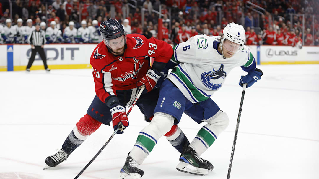 Tom Wilson battles for the puck in overtime at Capital One Arena.