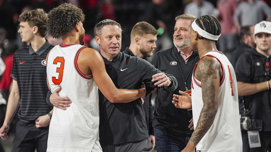 Jan 17, 2026; Athens, Georgia, USA; Georgia Bulldogs head coach Mike White reacts with guards Jordan Ross (3) and Marcus Millender (4) after Georgia defeated the Arkansas Razorbacks at Stegeman Coliseum. Mandatory Credit: Dale Zanine-Imagn Images