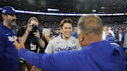 Los Angeles Dodgers pitcher Yoshinobu Yamamoto (18) celebrates with manager Dave Roberts (30) after defeating the Toronto Blue Jays in game seven of the 2025 MLB World Series at Rogers Centre on Saturday.