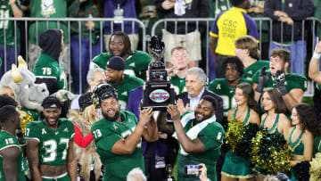 Dec 21, 2023; Boca Raton, FL, USA;  South Florida Bulls offensive lineman Donovan Jennings (73) and defensive end Immanuel Hickman (6) hold up the RoofClaim.com Boca Raton Bowl trophy after beating Syracuse Orange at FAU Stadium. Mandatory Credit: Nathan Ray Seebeck-USA TODAY Sports