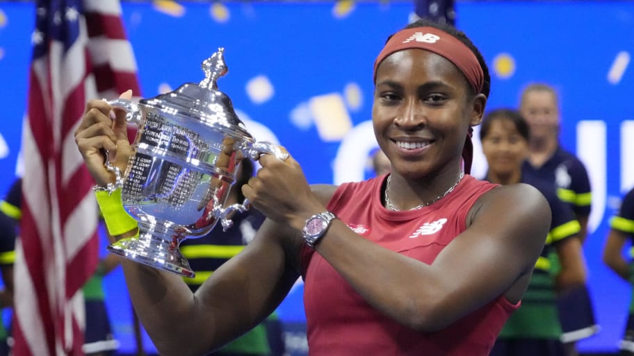 Coco Gauff poses with the U.S. Open trophy after winning the title in 2023.