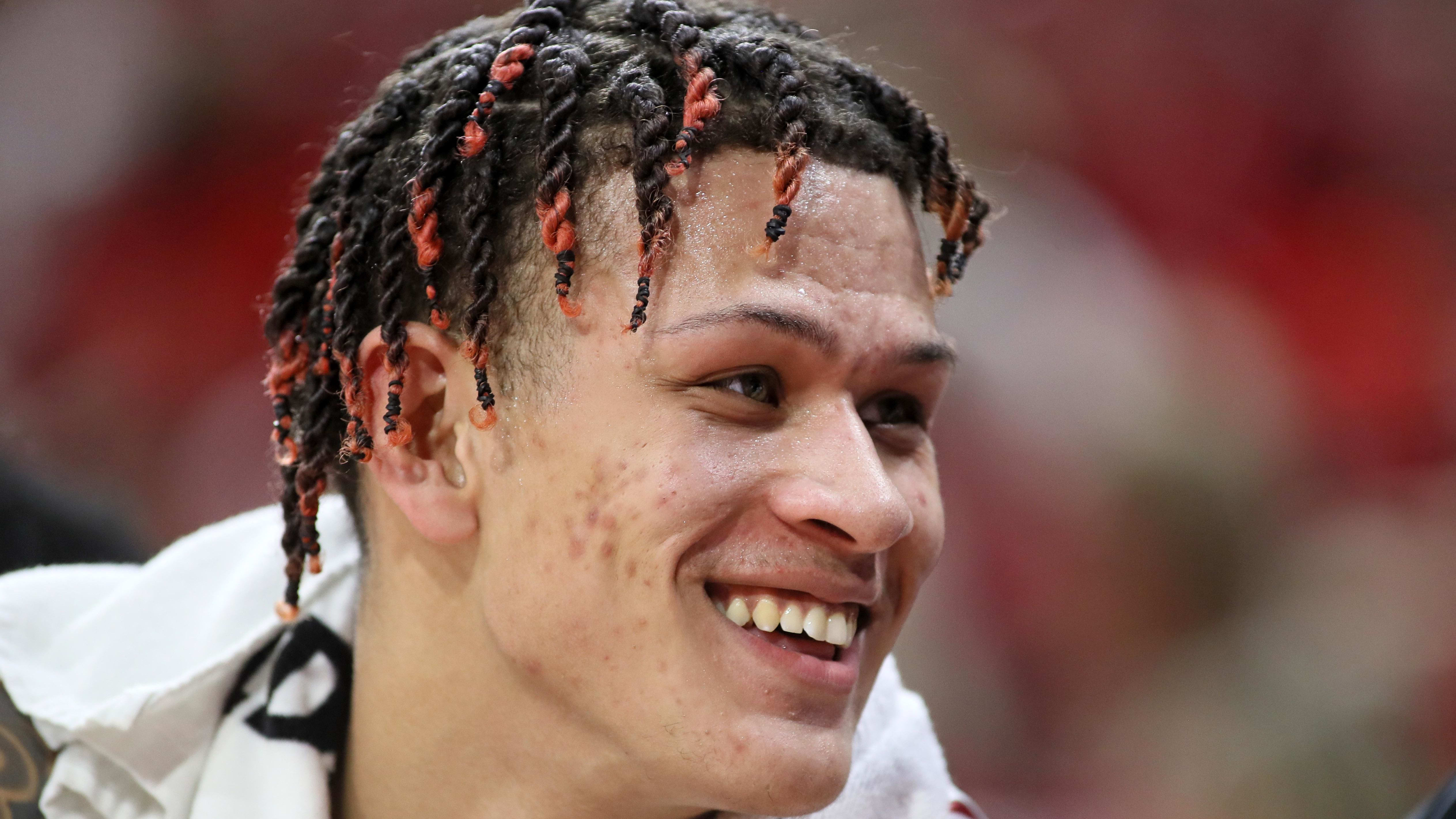 Arkansas Razorbacks forward Trevon Brazile laughs while on the bench. 