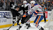 Apr 23, 2025; Los Angeles, California, USA; Los Angeles Kings left wing Andrei Kuzmenko (96) and Edmonton Oilers defenseman Ty Emberson (49) battle for the puck in the second period of game 2 of the 2025 Stanley Cup Playoffs at Crypto.com Arena. Mandatory Credit: Jayne Kamin-Oncea-Imagn Images
