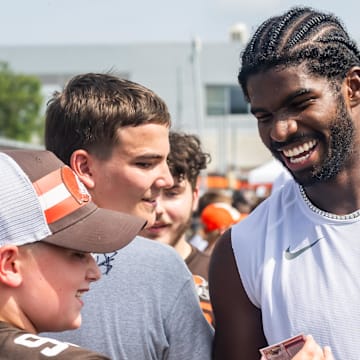 Jul 26, 2025; Berea, OH, USA; Cleveland Browns quarterback Shedeur Sanders (12) talks to a fan during training camp at CrossCountry Mortgage Campus. 