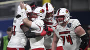 Dec 27, 2023; San Diego, CA, USA; Louisville Cardinals quarterback Evan Conley (6) celebrates with teammates after scoring a touchdown against the USC Trojans during the first half at Petco Park.