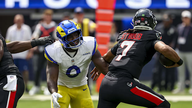 Sep 7, 2025; Inglewood, California, USA; Los Angeles Rams linebacker Byron Young (0) sacks Houston Texans quarterback C.J. St