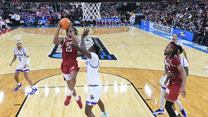 Mar 20, 2025; Providence, RI, USA;  Arkansas Razorbacks guard D.J. Wagner (21) controls the ball against Kansas Jayhawks forward Flory Bidunga (40) during the second half at Amica Mutual Pavilion. Mandatory Credit: Eric Canha-Imagn Images