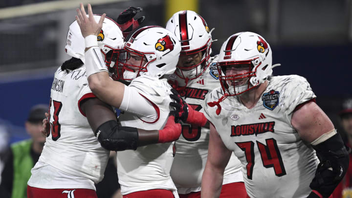 Dec 27, 2023; San Diego, CA, USA; Louisville Cardinals quarterback Evan Conley (6) celebrates with teammates after scoring a touchdown against the USC Trojans during the first half at Petco Park.
