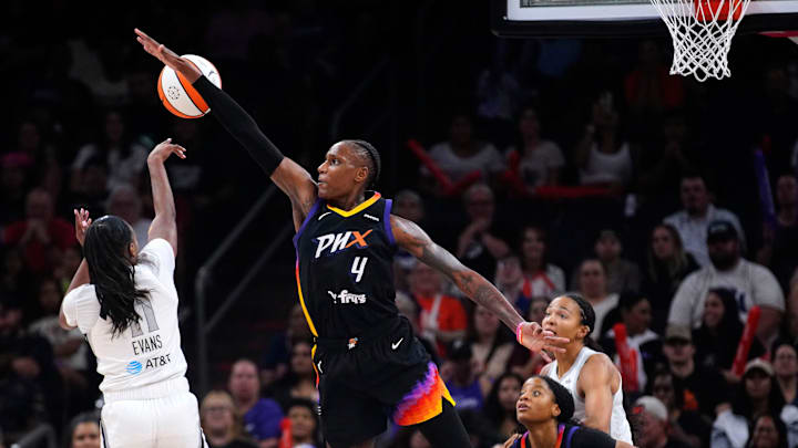 Aces guard Dana Evans (11) attempts to pass the ball around the defense of Mercury center Natasha Mack (4) during a game at PHX Arena in Phoenix, on Aug. 15, 2025. Aces guard Dana Evans (11) attempts to pass the ball around the defense of Mercury center Natasha Mack (4) during a game at PHX Arena in Phoenix, on Aug. 15, 2025.