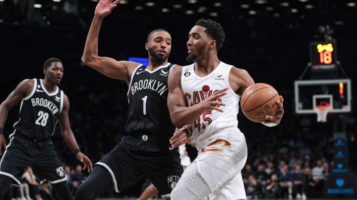 Mar 21, 2023; Brooklyn, New York, USA; Cleveland Cavaliers guard Donovan Mitchell (45) dribbles against Brooklyn Nets forward Mikal Bridges (1) during the first quarter at Barclays Center. Mandatory Credit: Vincent Carchietta-USA TODAY Sports