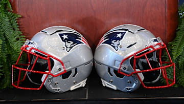Jan 13, 2025; Foxborough, MA, USA; A pair of New England Patriots helmets sit in front of the podium before a press conference at Gillette Stadium. Mandatory Credit: Eric Canha-Imagn Images