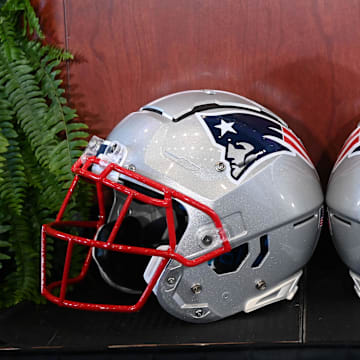 Jan 13, 2025; Foxborough, MA, USA; A pair of New England Patriots helmets sit in front of the podium before a press conference at Gillette Stadium. Mandatory Credit: Eric Canha-Imagn Images