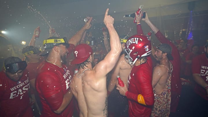 Sep 23, 2024; Philadelphia, Pennsylvania, USA; Philadelphia Phillies pitcher Carlos Estévez (53), first base Bryce Harper (3), second base Bryson Stott (5) and catcher Garrett Stubbs (21) celebrate the National League East Division title in the locker room after defeating the Chicago Cubsat Citizens Bank Park. Sep 23, 2024; Philadelphia, Pennsylvania, USA; Philadelphia Phillies pitcher Carlos Estévez (53), first base Bryce Harper (3), second base Bryson Stott (5) and catcher Garrett Stubbs (21) celebrate the National League East Division title in the locker room after defeating the Chicago Cubsat Citizens Bank Park.