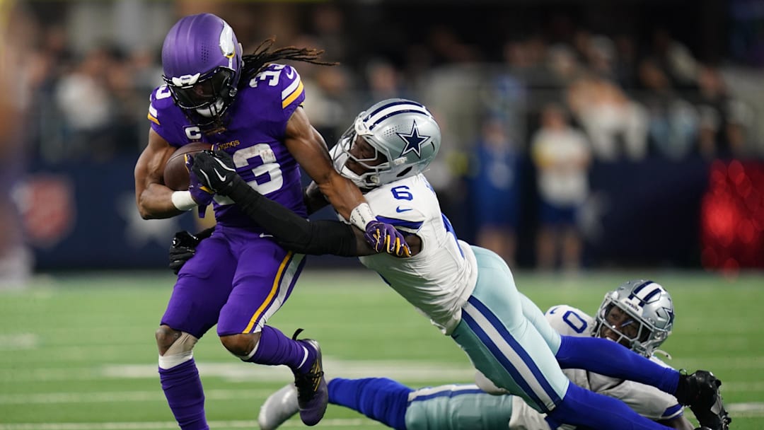 Dec 14, 2025; Arlington, Texas, USA; Minnesota Vikings running back Aaron Jones Sr. (33) runs against Dallas Cowboys safety Donovan Wilson (6) during the first half at AT&T Stadium. Mandatory Credit: Raymond Carlin III-Imagn Images