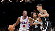 Nov 2, 2025; Brooklyn, New York, USA; Philadelphia 76ers guard Tyrese Maxey (0) sets the play while defended by Brooklyn Nets forward Michael Porter Jr. (17) and center Nic Claxton (33) during the first half at Barclays Center. Mandatory Credit: John Jones-Imagn Images