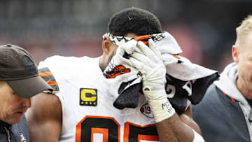 Dec 15, 2024; Cleveland, Ohio, USA; Cleveland Browns defensive end Myles Garrett (95) holds a towel over his face as he is escorted to the locker room following an injury during the second quarter against the Kansas City Chiefs at Huntington Bank Field. Mandatory Credit: Scott Galvin-Imagn Images