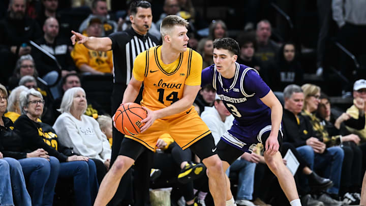 Feb 8, 2026; Iowa City, Iowa, USA; Iowa Hawkeyes guard Bennett Stirtz (14) controls the ball as Northwestern Wildcats guard Jake West (3) defends during the first half at Carver-Hawkeye Arena. Mandatory Credit: Jeffrey Becker-Imagn Images