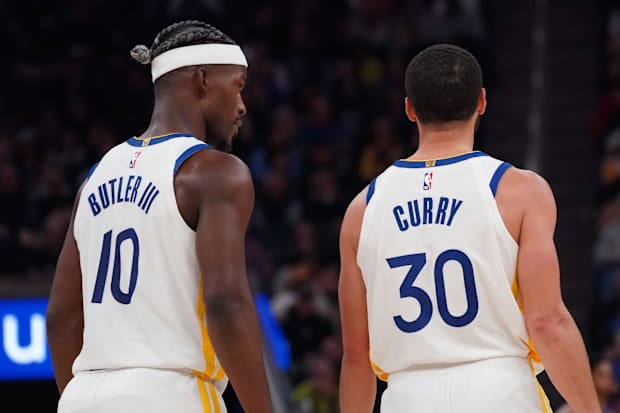 Golden State Warriors forward Jimmy Butler III (10) talks with guard Stephen Curry (30) 