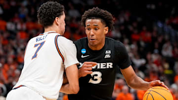 Xavier Musketeers guard Dailyn Swain (3) drives against Illinois Fighting Illini forward Will Riley (7) in the second half of the NCAA Tournament First Round game between the Illinois Fighting Illini and the Xavier Musketeers at Fiserv Forum in Milwaukee on Friday, March 21, 2025. Xavier was eliminated from the tournament, losing 86-73, to Illinois.