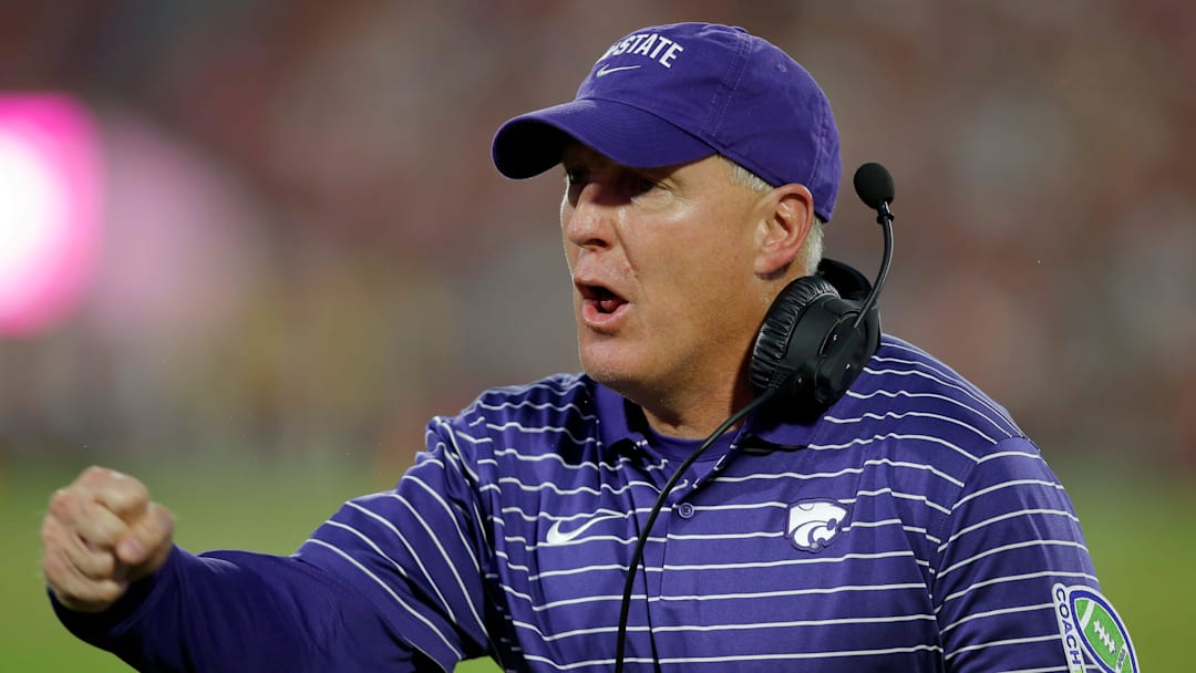 Kansas State head coach Chris Klieman celebrates after a Kansas State touchdown tramel -- jump