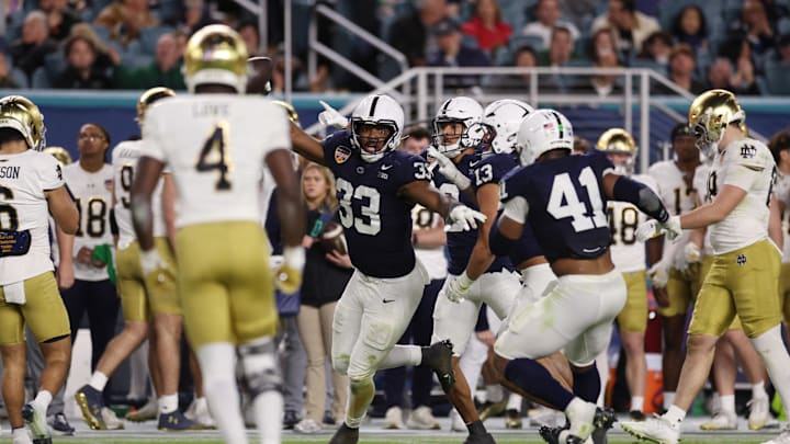 Jan 9, 2025; Miami, FL, USA; Penn State Nittany Lions defensive end Dani Dennis-Sutton (33) intercepts the ball in the second half against the Notre Dame Fighting Irish in the Orange Bowl at Hard Rock Stadium. Mandatory Credit: Nathan Ray Seebeck-Imagn Images