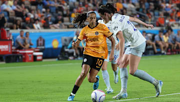 Houston Dash midfielder Andressa Alves (10) plays the ball defended by Seattle Reign FC defender Phoebe McClernon (21)  