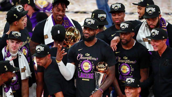 Oct 11, 2020; Lake Buena Vista, Florida, USA; Los Angeles Lakers forward LeBron James (23) holds up four fingers after winning his fourth NBA championship after game six of the 2020 NBA Finals at AdventHealth Arena. The Los Angeles Lakers won 106-93 to win the series. Mandatory Credit: Kim Klement-Imagn Images