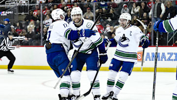 Mar 24, 2025; Newark, New Jersey, USA; Vancouver Canucks left wing Jake DeBrusk (74) reacts after a goal by Vancouver Canucks center Pius Suter (not pictured) during the third period against the New Jersey Devils at Prudential Center. Mandatory Credit: John Jones-Imagn Images