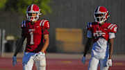 Brophy Prep wide receivers Devin Fitzgerald (1) and Donovan McNabb Jr. (85) listen to coaches during a practice at Brophy College Prepatory in Phoenix on Sept. 4, 2024.