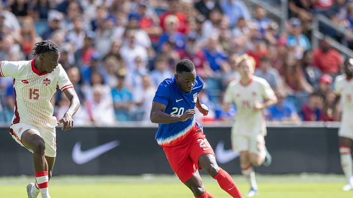 USMNT striker Folarin Balogun dribbles the ball against Canada.