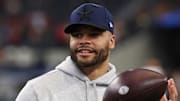 Dallas Cowboys quarterback Dak Prescott stands on the field before a game.