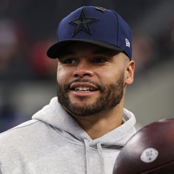 Dallas Cowboys quarterback Dak Prescott stands on the field before a game.