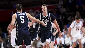 Jan 4, 2025; Dallas, Texas, USA;  Duke Blue Devils guard Cooper Flagg (2) celebrates with Duke Blue Devils guard Tyrese Proctor (5) during the second half against the Southern Methodist Mustangs at Moody Coliseum. Mandatory Credit: Kevin Jairaj-Imagn Images
