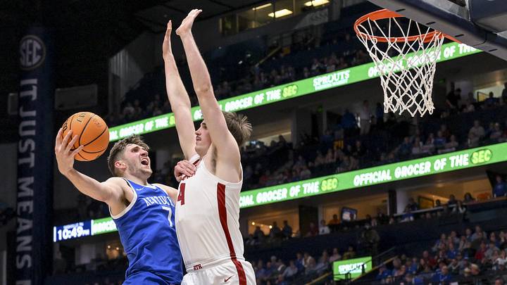 Mar 14, 2025; Nashville, TN, USA;  Kentucky Wildcats forward Andrew Carr (7) shoots over  Alabama Crimson Tide forward Grant Nelson (4) during the second half at Bridgestone Arena. Mandatory Credit: Steve Roberts-Imagn Images