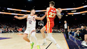 Nov 16, 2025; Phoenix, Arizona, USA; Atlanta Hawks guard Vit Krejci (27) and Phoenix Suns guard Collin Gillespie (12) match up during the second half of a game at Mortgage Matchup Center.