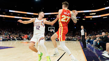 Nov 16, 2025; Phoenix, Arizona, USA; Atlanta Hawks guard Vit Krejci (27) and Phoenix Suns guard Collin Gillespie (12) match up during the second half of a game at Mortgage Matchup Center.