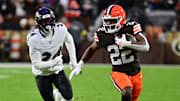Nov 16, 2025; Cleveland, Ohio, USA; Cleveland Browns running back Dylan Sampson (22) runs for a gain past Baltimore Ravens safety Malaki Starks (24) during the first quarter at Huntington Bank Field. Mandatory Credit: Ken Blaze-Imagn Images