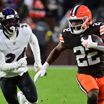 Nov 16, 2025; Cleveland, Ohio, USA; Cleveland Browns running back Dylan Sampson (22) runs for a gain past Baltimore Ravens safety Malaki Starks (24) during the first quarter at Huntington Bank Field. Mandatory Credit: Ken Blaze-Imagn Images