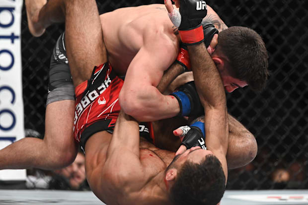 Ilia Topuria (blue gloves) defeats Jai Herbert (red gloves) during UFC Fight Night at O2 Arena. 