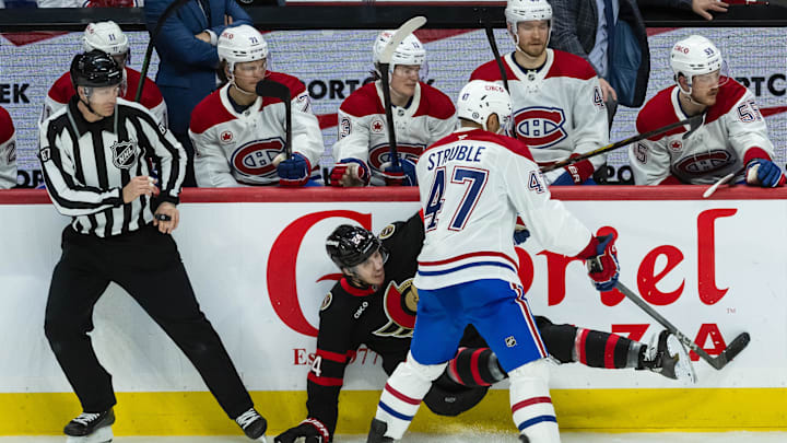 Apr 11, 2025; Ottawa, Ontario, CAN; Ottawa Senators center Dylan Cozens (24) is checked by Montreal Canadiens defenseman Jayden Struble (47) in the third period at the Canadian Tire Centre. Mandatory Credit: Marc DesRosiers-Imagn Images