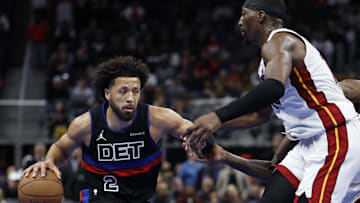 Nov 12, 2024; Detroit, Michigan, USA;  Detroit Pistons guard Cade Cunningham (2) dribbles defended by Miami Heat center Bam Adebayo (13): Rick Osentoski-Imagn Images