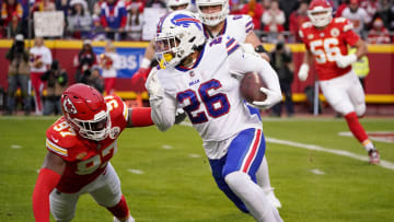 Dec 10, 2023; Kansas City, Missouri, USA; Buffalo Bills running back Ty Johnson (26) runs the ball as Kansas City Chiefs defensive end Felix Anudike-Uzomah (97) attempts the tackle during the first half at GEHA Field at Arrowhead Stadium. Mandatory Credit: Denny Medley-USA TODAY Sports