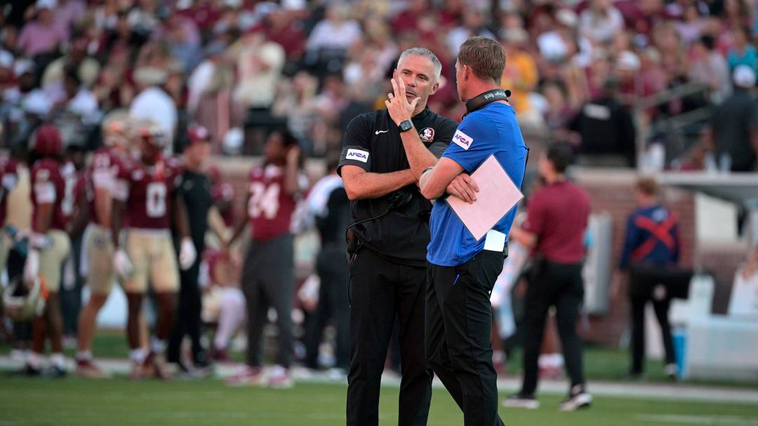 Sep 7, 2026; Tallahassee, Florida, USA;  Florida State Seminoles head coach Mike Norvell and Southern Methodist Mustangs head coach Rhett Lashlee talk during a delay due to a power outage before the game at Doak S. Campbell Stadium.  Mandatory Credit: Melina Myers-Imagn Images