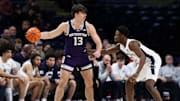 Jan 2, 2025; University Park, Pennsylvania, USA; Northwestern Wildcats guard Brooks Barnhizer (13) dribbles against Penn State Nittany Lions guard D'Marco Dunn (2) during the first half at Bryce Jordan Center. Mandatory Credit: Matthew O'Haren-Imagn Images