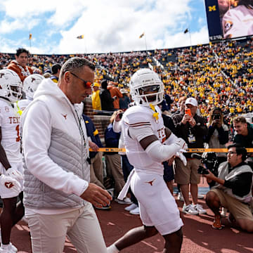 Sep 7, 2024; Ann Arbor, Michigan, USA; Texas head coach Steve Sarkisian and the Texas players take the field for warm ups at Michigan Stadium. Mandatory Credit: Junfu Han-USA TODAY Network via Imagn Images